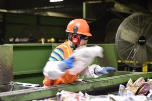 Two photos: Workers manually remove contaminants from conveyor belts of divided materials – at first, picking out stuff that shouldn’t have been recycled at all, and then looking for stuff that imperfect machines sent into the wrong lane. In order for the MRF to function, the facility relies on Rhode Islanders to follow the basic rules of recycling. (Credit: Vin Sowders)