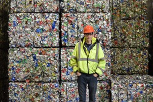 Brian Dubis, operations supervisor at the MRF, stands in front of finished bales of sorted recycling. (Credit: Vin Sowders)