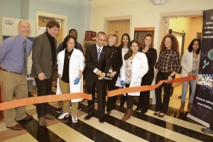 Providence Mayor Jorge Elorza (5th from left) demonstrates proper spaying and neutering technique using giant ceremonial scissors, accompanied by former school superintendent Dr. Susan Lusi (6th from left) and URI professor Dr. Albert Kausch (2nd from left), both of whose doctorates have absolutely nothing whatsoever to do with veterinary medicine. (Photo: Providence School Department)